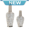 Let seaside design wash over your mantel or table with this gorgeous coastal-inspired vase. It features a tall stoneware construction decorated with beautiful seashells and topped with a metallic lip. It will complement any style of decor and be a eye-catching conversation starter.