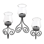 What a beautiful way to add light up your table! This gorgeous centerpiece features a scrolling black metal stand that holds three glass candle cups at varying heights. Insert the candles of your choice and let the flickering flames shed a lovely glow on your tabletop.