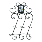 Be prepared for a celebration when you have three bottles of wine and four wine glasses mounted to your wall with this pretty wrought iron scrollwork rack. Add your favorite portrait at top. 