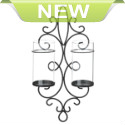 Light up your wall with gorgeous glow that will shimmer and shine with everlasting style. This beautiful iron wall sconce features two clear hurricane lanterns that are ready for your favorite pillar candles.