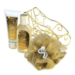 Give a special bath gift set for someone on your nice list this holiday! A golden wire sleigh holds Glam shower gel and body lotion as well as a gold pouf. Golden vanilla dew fragrance. 