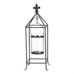 Oh la la! Candlelight with a touch of European flair is a surefire way to amp up the style in your room. This metal candle stand features a black rod framework topped with a fleur-de-lis finial. Inside, a clear glass candle cup hangs from a simple metal frame that will let the light shine bright.