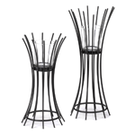 A dramatic way to display votive candles, this duo features black metal sticks that flare out to hold glass candle cups. Just add candles and enjoy! 