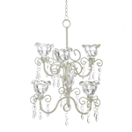 Gorgeous crystal flowers bloom to create a romantic lighting feature for your favorite room. The ivory metal scrollwork holds six clear candle cups as dramatic faceted jewels hang down to capture the candlelight. 