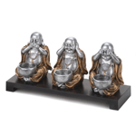 Three happy Buddhas remind us to speak no evil, hear no evil, and see no evil. This charming lighting accent features a dark wood base and three seated Buddhas that each hold a candle cup. Candles not included.