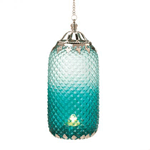 An exquisite diamond-patterned lantern steeped in decadent turquoise and encircled by sophisticated silver-toned filigree makes a worldly statement. Light a candle and watch the room twinkle with exotic flair.