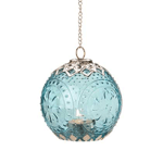 International design comes home with this beautifully detailed hanging candle lantern. Sea color glass imprinted with a timeless pattern is framed perfectly by intricate filigree, all suspended by a glittering chain. Hang it, light a candle inside, and enjoy!