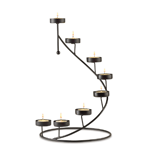 Crown any tabletop with a shimmering spiral of golden light! Matte-black candleholder cradles eight tealight votives in a breathtaking stair-step display. Dramatic alone, or circle around a vase of fresh flowers for an instantly elegant centerpiece!