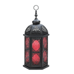 Spice up your night with the warm and inviting glow from this Moroccan-style candle lantern. Red pressed glass panels are set in an ornate black metal frame with flowery cutouts. Open the hinged door to place the candle of your choice inside, and then set the lantern on your table or hang it from the top loop for instant pizzazz!