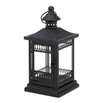 esisting the charm of this black garden lantern is impossible! The black metal framework features intricate Victorian-inspired embellishments that will enhance the glow of a candle inside. 