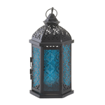 Calming azure hues sparkle and glow, splashing your room with peaceful tidings. Put your favorite candle inside this gorgeous black iron lantern and delight as the intricate cutouts and patterns come alive with candlelight. Hang it from the top loop or set it on your tabletop.