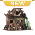 Birds will love making this scout camp trading post their home! Its perfectly decorated with all the delightful trimmings youd find during a summer camp getaway, including canoe paddles, American flag, and evergreen trees. 