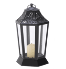 A glossy jet-black finish highlights every pretty curve and cutout of this six-panel lantern. Utterly enchanting when filled with golden candlelight, this hurricane style lamp is an attractive accent even during the day!