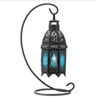 Candle light glimmers through lacy designs, turned into sapphire rays of light. This graceful hanging tabletop lantern enchants your home with the magic of a desert night!