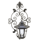 Delicate scrollwork wall plate and classic hurricane lamp make a gracious addition to your outdoor living space; hidden solar collectors store sunlight for plentiful after-dark illumination. The perfect fusion of smart energy savings and old fashioned charm!Four solar panels on top of the lantern. Two holes on back for mounting.