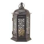 Put a candle of your choice inside this effervescent candle lantern and enjoy the bubbly atmosphere it creates. This dark metal lantern’s design pattern features circles of various sizes that make an entertaining display of light and shadow indoors or out.