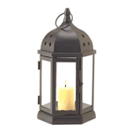 This tabletop candle lantern is a study in elegant simplicity. Embellished with clear glass panels and a triad of circular cutouts atop the black metal lantern frame, place a candle inside for the perfect testament to easy elegance.