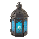 Like the blue of an exotic summer sky, the patterned glass of this candle lantern will invigorate and inspire. Highlighted perfectly by the intricate design of the filigree metal frame, this candle lantern is sure to fill your room with exotic flair.