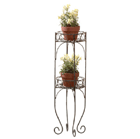 Lacy scrolls in a verdigris-style finish comprise this two-shelf plant stand. A graceful addition for indoors or out; shelves securely hold two of your favorite plants!