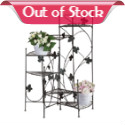 Airy strands of ivy grace this staircase style plant stand. Six shelves place plants at graduating heights, creating a dramatic display of greenery