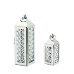 Candlelight has never been so glamorous! These gorgeous silver metal lanterns features an intricate inset pattern with shimmering crystals that reflect the light from inside. Features a top hanging loop.