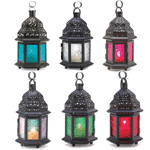 Intricate cutout metalwork blazes with light as a candle sets this lantern aglow. A decorating treasure inspired by the mysteries of the fabled Far East! In Green, Red, Blue, or Clear.