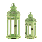 Intricate cutouts decorate the green finish of this exotic Tower candle lantern. The slender clear glass panels allow candlelight to shine brightly while the metal frame allows to hanging or setting on a tabletop.