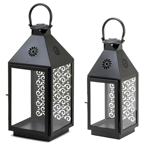 Indoors or outside on the patio, this large iron candle lantern will give your living space a splash of style and dash of candlelight. It features three glass panels and an intricate cutout design on the back that will make the candles glow truly delightful.