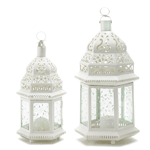 Candlelight shines from the cutout design of this lovely, lacy ivory lantern! It's hexagonal hurricane shape in creamy ivory is stunning against lush garden greenery, casting a gracious golden glow on a twilit summer's night.