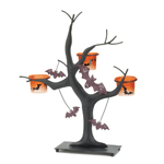 This candle holder is no trick and all treat! A stylized black tree holds three orange candle cups decorated with bat silhouettes while sparkling bat cutouts hang nearby. Add the candles of your choice to create an eerie glow that will complete your Halloween décor.