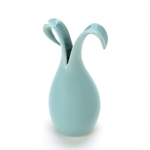 An artistic ode to the beauty of a lily in bloom set in pale blue ceramic. The base of this gorgeous vase rises up and forms two blossoming petals that will accent your room with delicate beauty. 