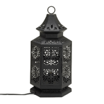 The gorgeous cutouts of this black metal table lamp create intricate and varied patterns when the single bulb lights up. It glows with worldly style and exotic allure, and will be perfectly at home in your living space. Place it on your entry table as a welcoming beacon, or use it to brighten a shadowy corner. 