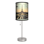 Like a love letter from The City of Light, this Paris Post Card Lamp will light your space with lovely continental style. This slim tabletop lamp is perfect for small tables or desks, and a simple pull on the stainless steel chain will light up the sunset image of the Eiffel Tower thats set on a backdrop of bi-wing airplanes. Youll say bonjour to style when you add this lighting accent to your room. Made in USA. Wipe clean with dry cloth.