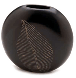 Simple and striking, this circular wooden vase serves beautifully as a handsome backdrop for a grouping smaller objects, or on its own as a dramatic focal point. Graceful carved leaf adds natural appeal.