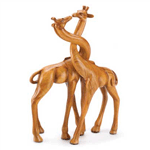 A pair of giraffes shyly shares a smooch, with graceful necks intertwined. A whimsical interpretation of love in the wild, with the beautiful look of hand-carved wood!