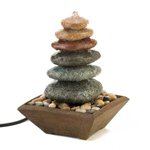 The sound of water cascading over perfectly balanced stacked stones makes this a welcome meditation destination in your home. This fountain features multi-colored stones resting on a bed of pebbles, collected in a simple and lovely wood-liked base.