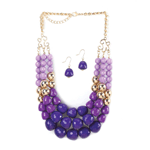 Three rows of dazzling orchid tonal faceted beads will make a stunning statement about your style! This pretty necklace also features golden beads that shimmer in the light, and the matching purple dangle earrings are the perfect complement.