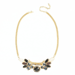 Dazzle your way through the day and night with this stunning statement necklace. The thick golden chain gets a serious style treatment by way of a smoldering set of white, brown and smoky black stones that will complete your outfit.