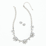 Sparkle and shine thats fit for a queen! This cool jewelry set features sparkling clear stones that gather like icy crystals and are set on an adjustable silvery chain. The matching earrings are the perfect finishing touch. 