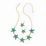 Set sail on a sea of style with this show-stopping jewelry set. Five gloriously green starfish with black and gold accents are set in a golden adjustable-length necklace, while two more starfish make up the matching dangle earrings.