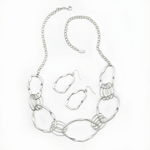 Go with the flow of fashion! Beautiful wavelike circles mix and mesh together to great a fantastic adjustable-length necklace, and the matching earrings are the perfect accompaniment.