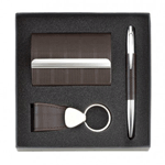 This handsome gift set features a pen, key ring, and business card holder covered with brown faux leather and highlighted with silver metal accents.