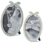 Your precious memories deserve a frame that is equally special. This beautiful 5x7 or 4x6 oval photo frame features a row of dazzling rhinestones topped with a glittering rhinestone bow and has an easel back for tabletop display. Pewter & Glass.