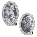 Your sparkling photos deserve to be wrapped in sparkling jewels! This oval photo frame features three rows of clear, glittering rhinestones and an easel back for tabletop display. Pewter & Glass. 