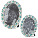 The gorgeous sea-colored cabochons set in pewter that surround this oval photo frame will make your favorite photo memory shine. Its ready for your 5x7 or 4x6 photo and has an easel back for tabletop display. Glass & Pewter.