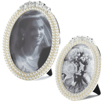 Classic pearl strands are the perfect showcase for your special memories. This oval photo frame fits a 5x7 or 4x6 photo and features two rows of faux pearls topped with glittering stones along with an easel stand for tabletop display. Zinc Alloy, Glass.