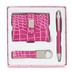 Dress up the inside of your purse or briefcase with this glamorous pink executive gift set. It features a pen, key ring, and business card holder, all covered with deep pink faux snakeskin and accented with glittering crystals. 